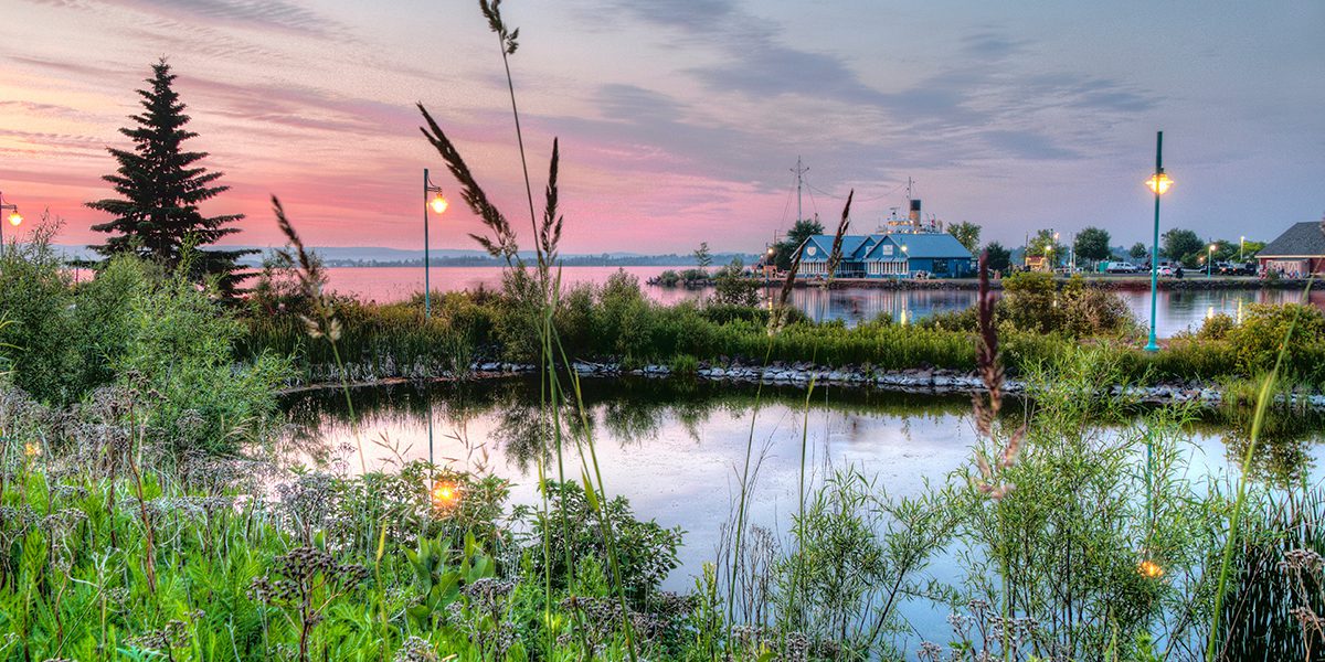 blue buildings on the shore of a lake