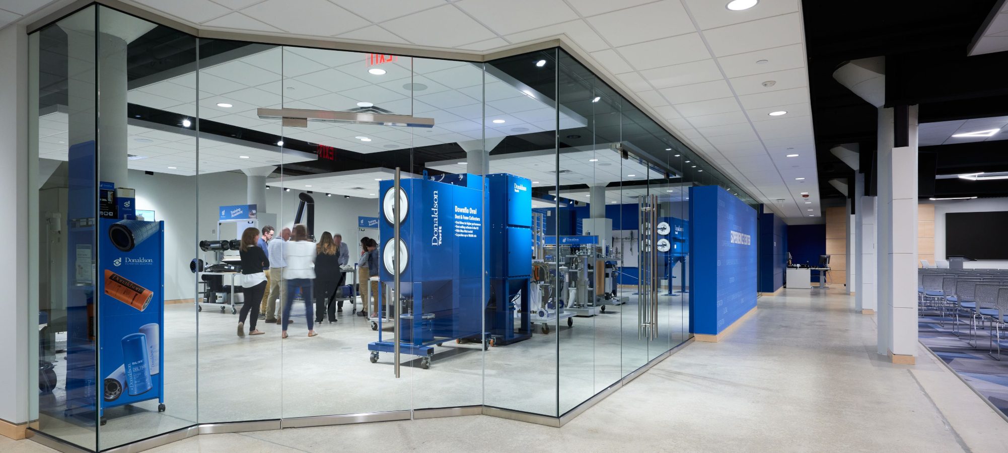 Corporate training area with blue signage and glass wall