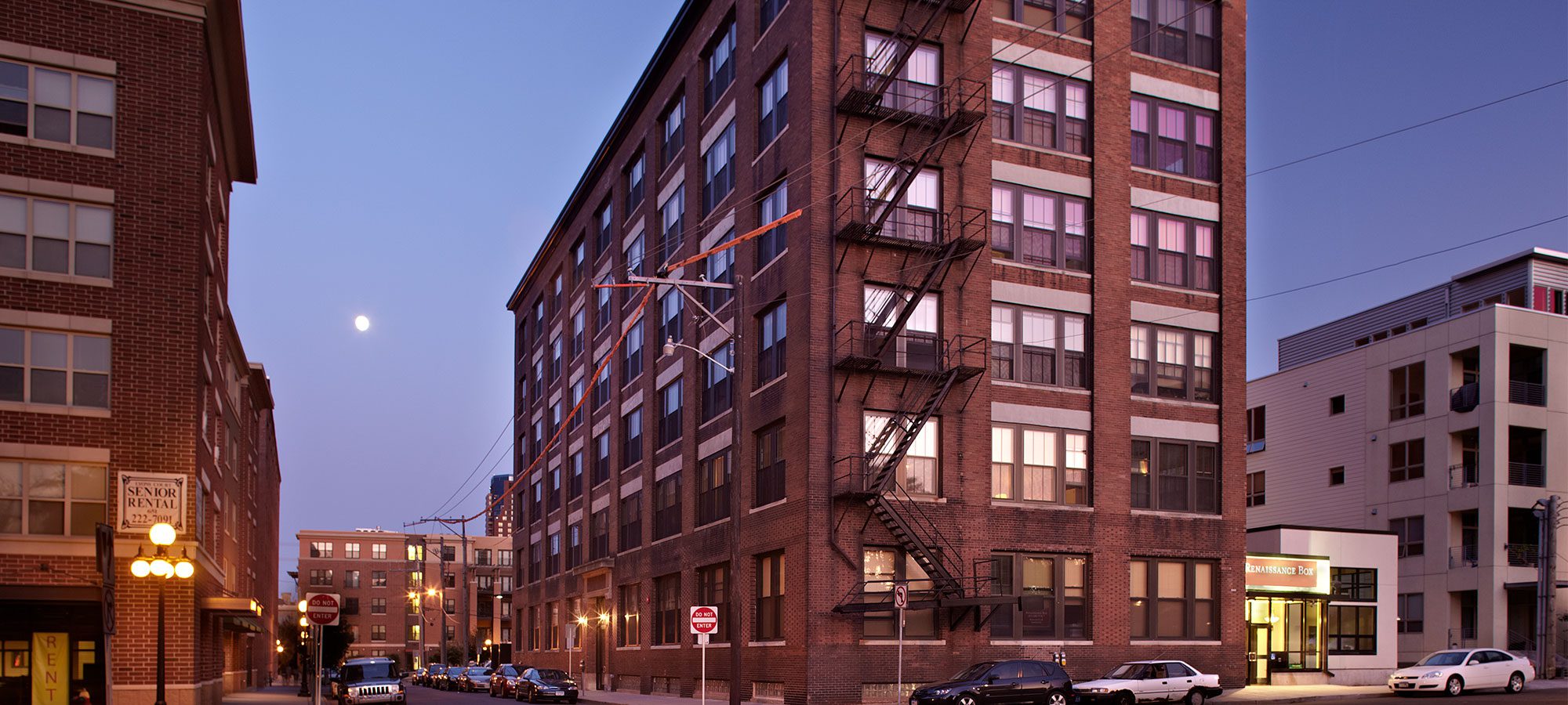 exterior view of a brick and stone building with a fire escape
