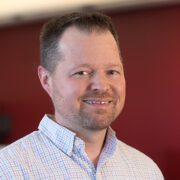 portrait of man in blue jacket and white shirt