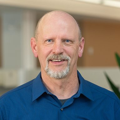 portrait of a man in blue shirt