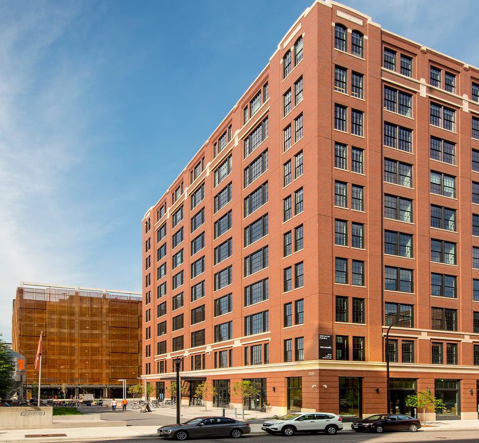 Brick office building and plaza along a city street
