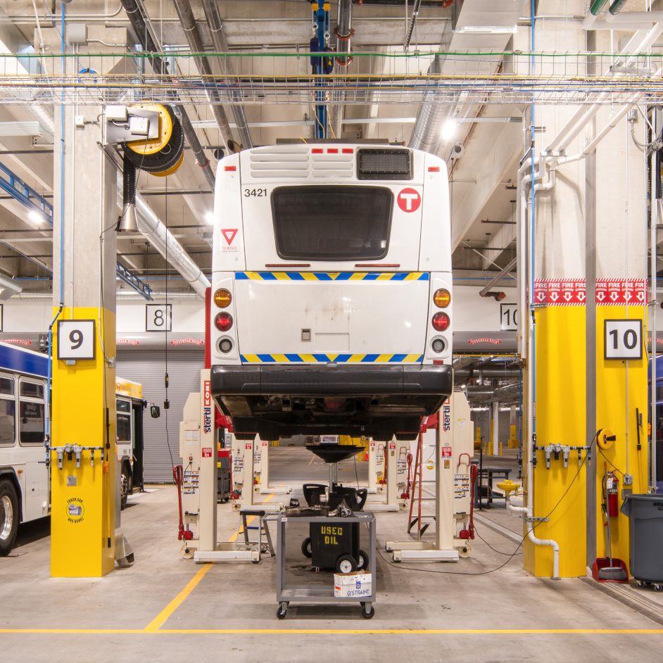 Bus on lifts for mechanical repair in electric bus garage