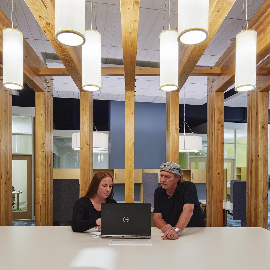 Two people at table in office