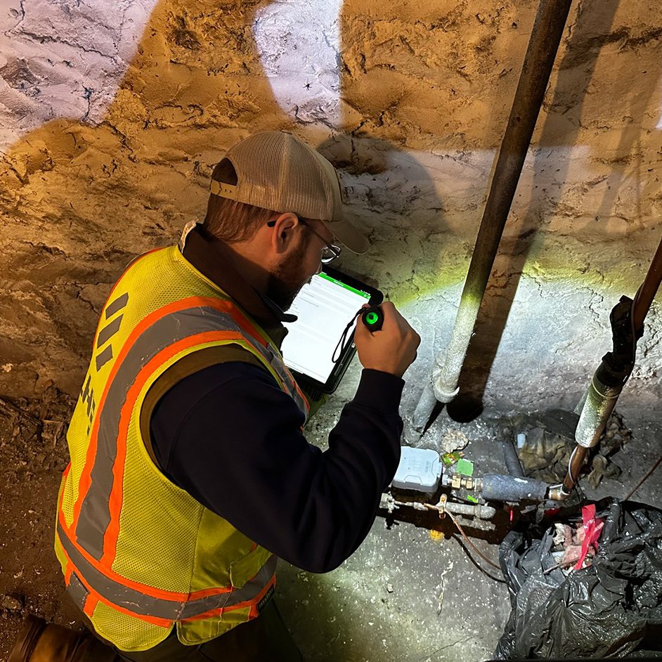 A man inspects water pipes