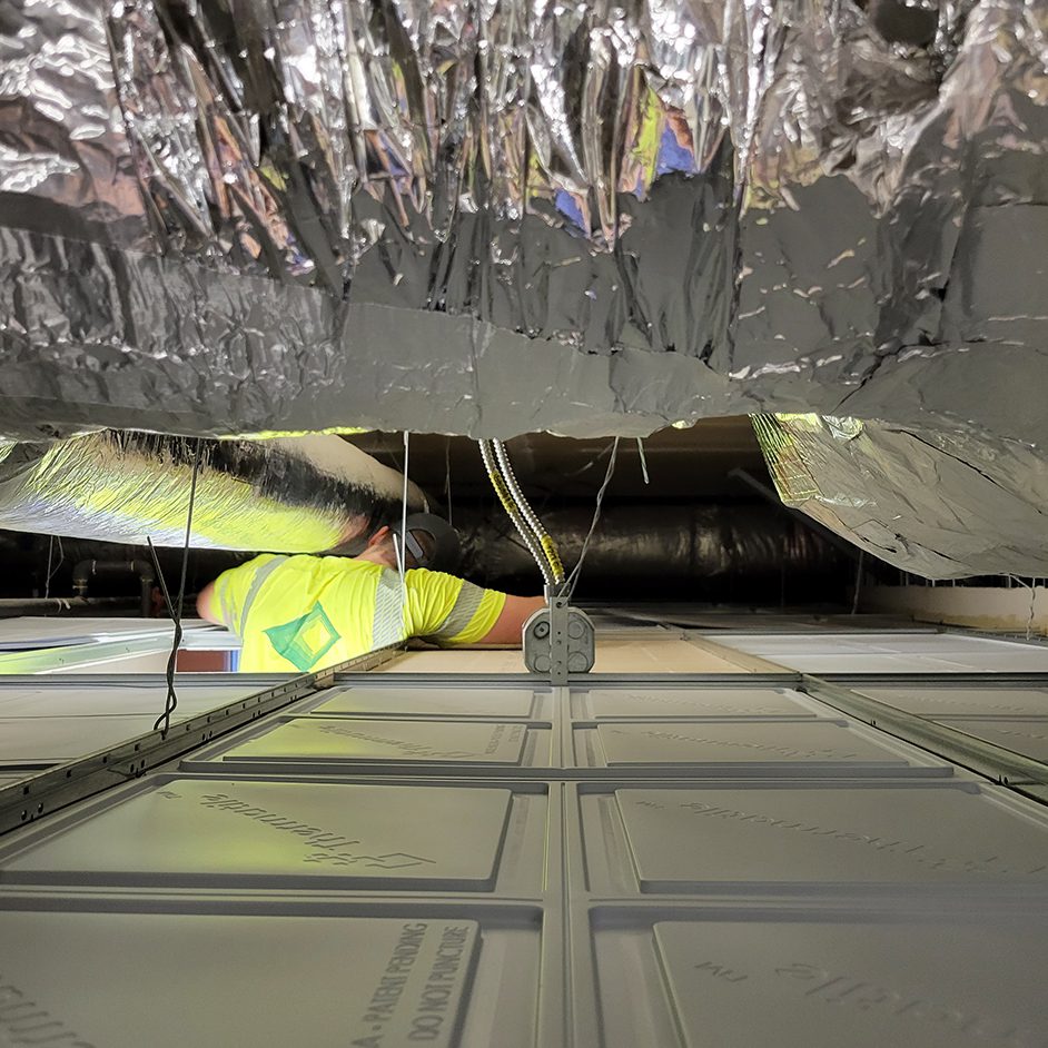 Man working inside ceiling