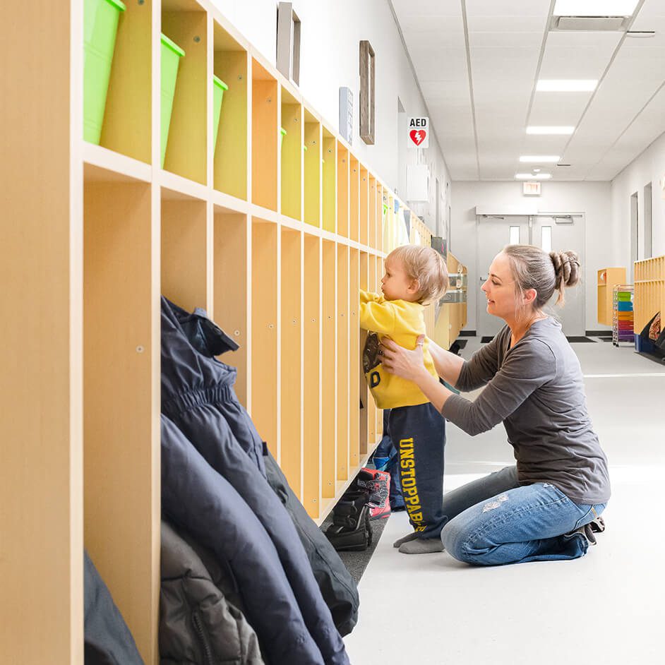 Child and adult at school cubbies